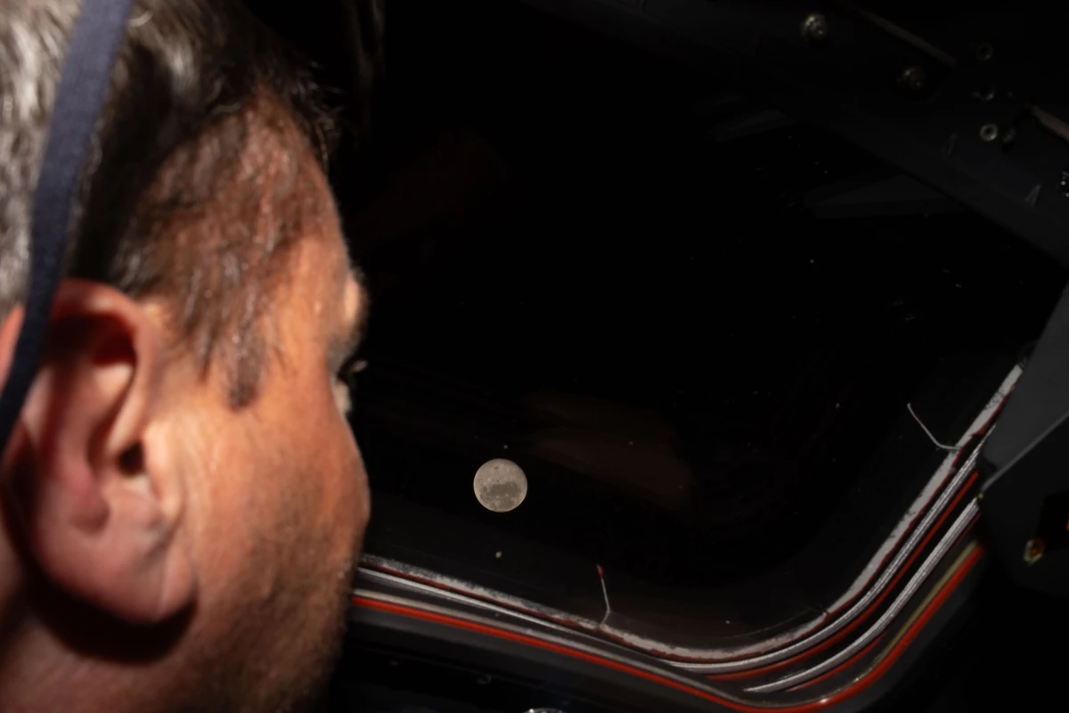 Artemis II commander Reid Wiseman looks out one of the Orion spacecraft's main cabin windows at the Moon ahead of the crew's historic lunar flyby on Monday.