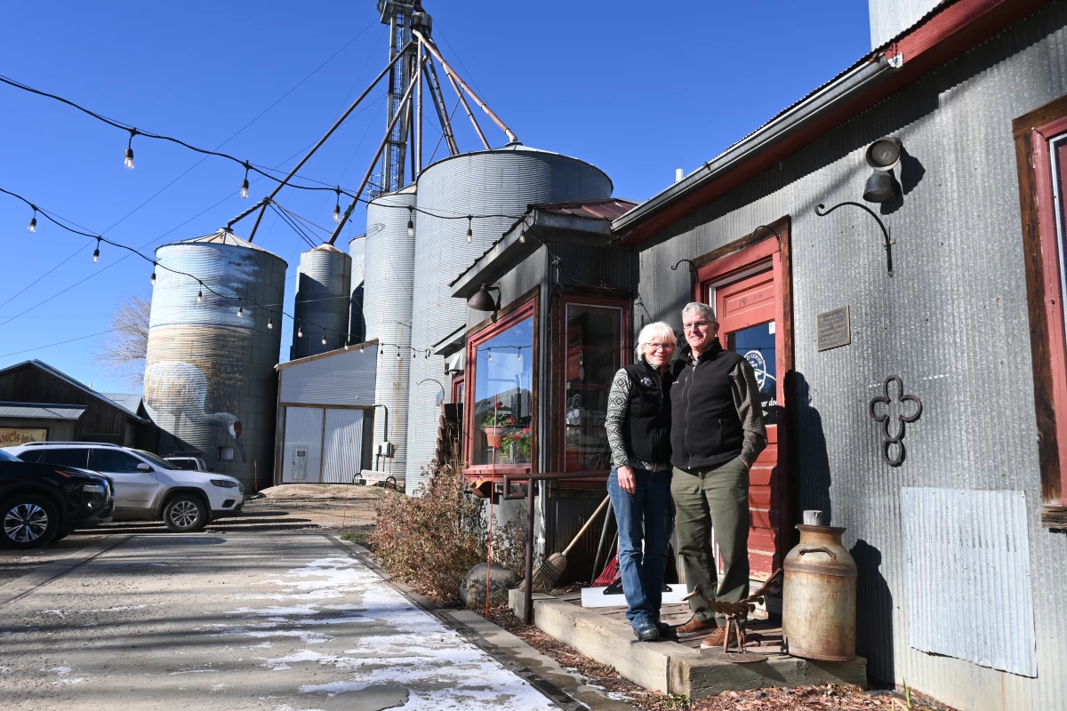 Tammie (left) and Patrick Delaney pose in front of the Wild Goose coffee shop in Hayden, Colo., in November 2024. The Delaneys have concerns about the idea of using trains to import spent nuclear fuel to northwest Colorado.