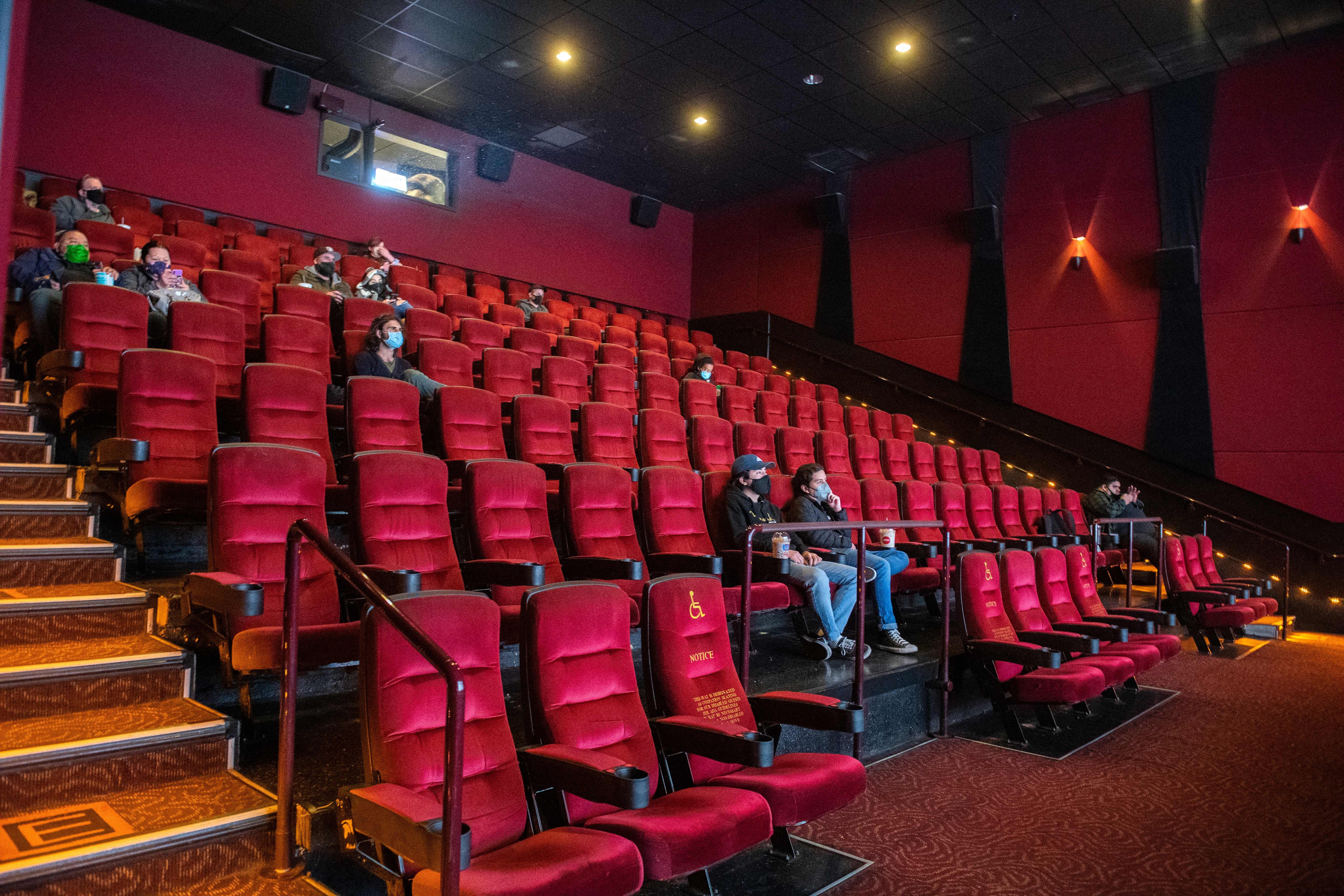 Moviegoers wait for their movie to start at the AMC Burbank in Burbank, Calif. on reopening day in March 2021.