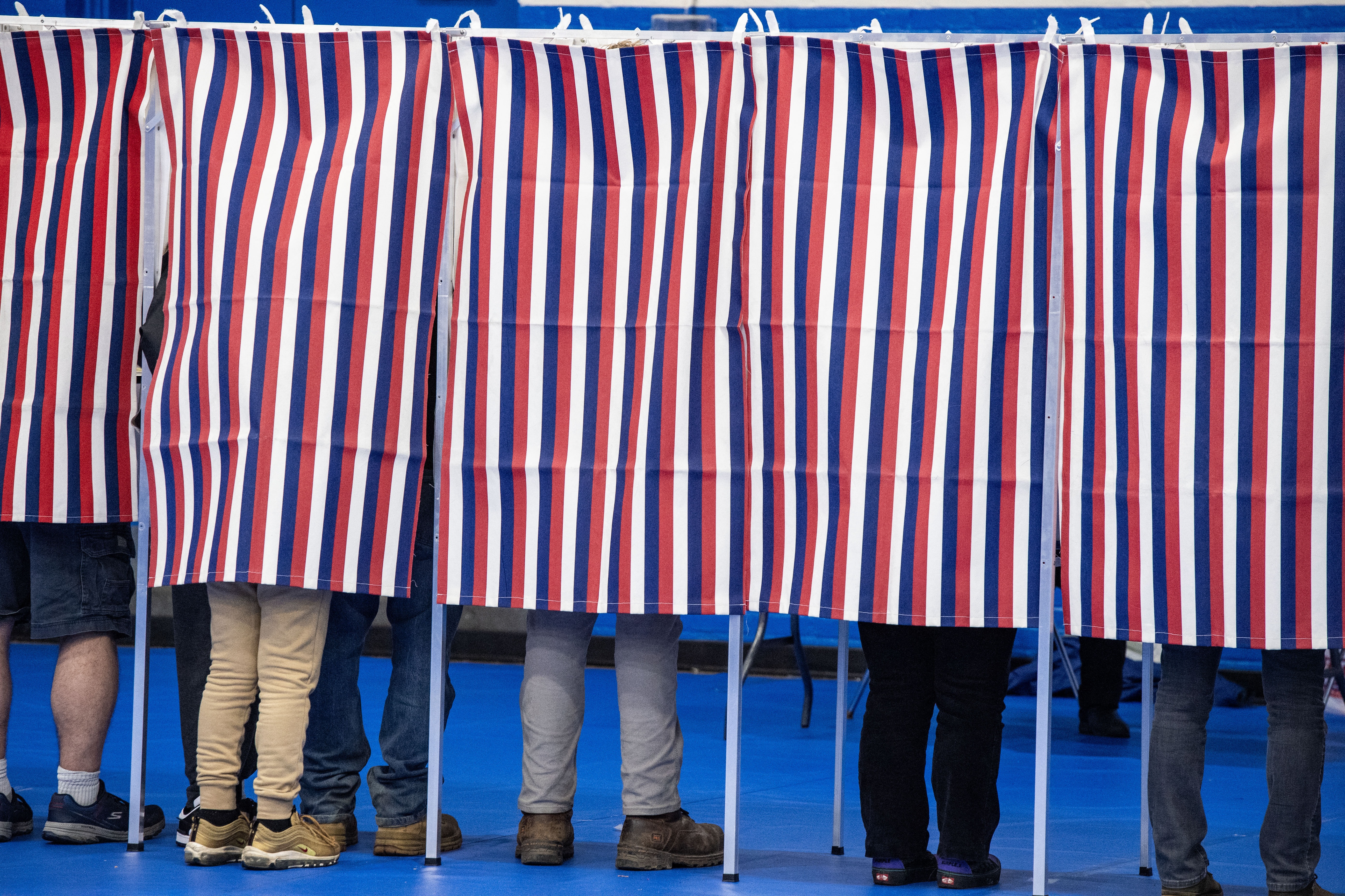 People fill out their ballots in voting booths at the Green Street Community Center in Concord, N.H., on Nov. 5, 2024.