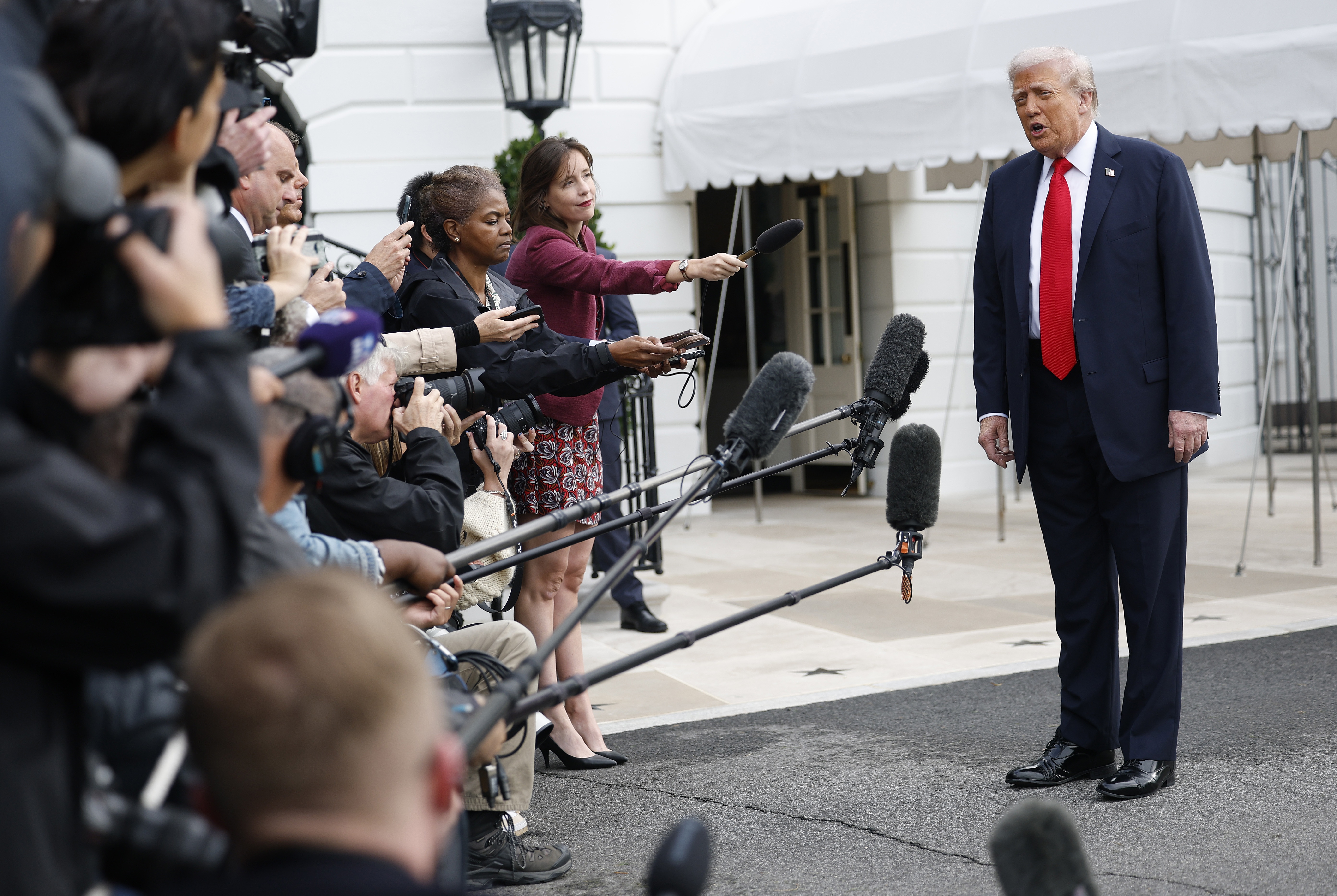 President Trump speaks to members of the media as he departs the White House en route to London on Sept. 16, 2025.