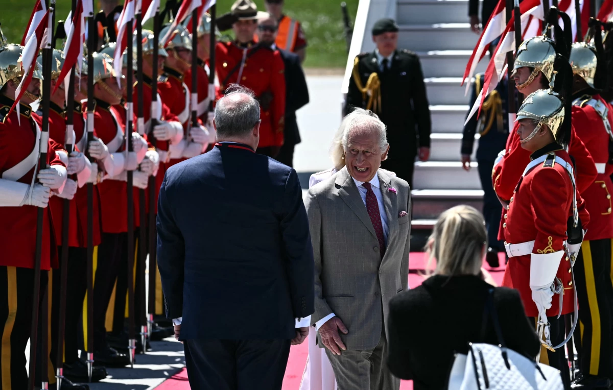 Britain's King Charles III is greeted by an honor guard after arriving at Macdonald-Cartier International Airport in Ottawa, Canada, on Monday.