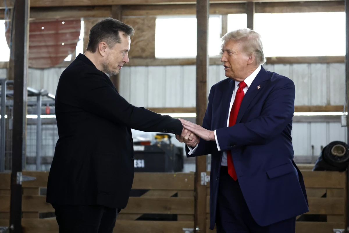 President-elect Trump shakes hands with Elon Musk at a campaign stop in Butler, Pa., on October 5, 2024. Trump has named Musk and former presidential hopeful Vivek Ramaswamy co-leaders of a new commission called the 'Department of Government Efficiency,' which will advise and guide Trump in his quest to 'dismantle government bureaucracy.'