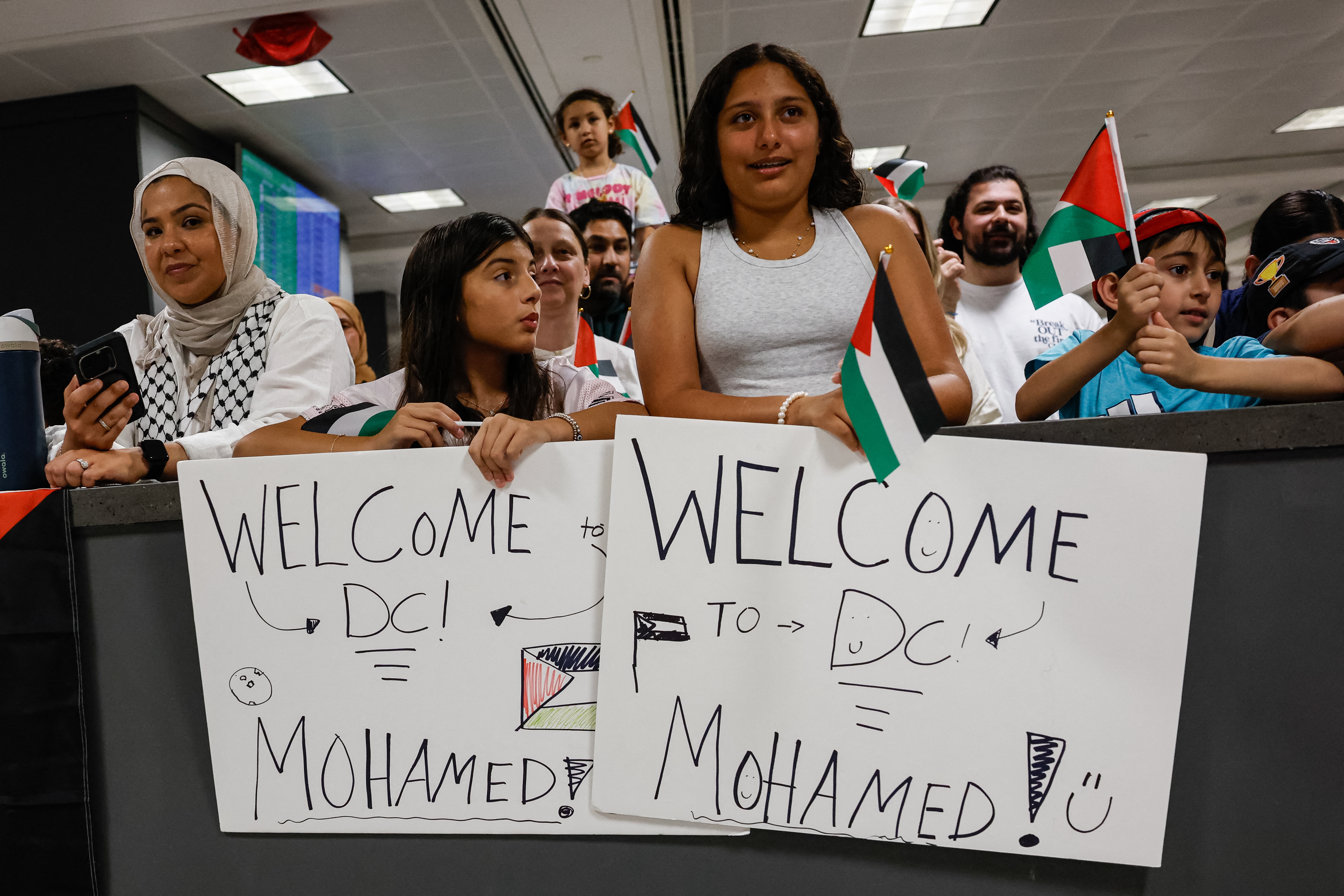 A group of people gather to greet two severely wounded Palestinian teenagers from Gaza arriving at Dulles International Airport near Washington for urgent medical treatment on Aug. 9, 2025.