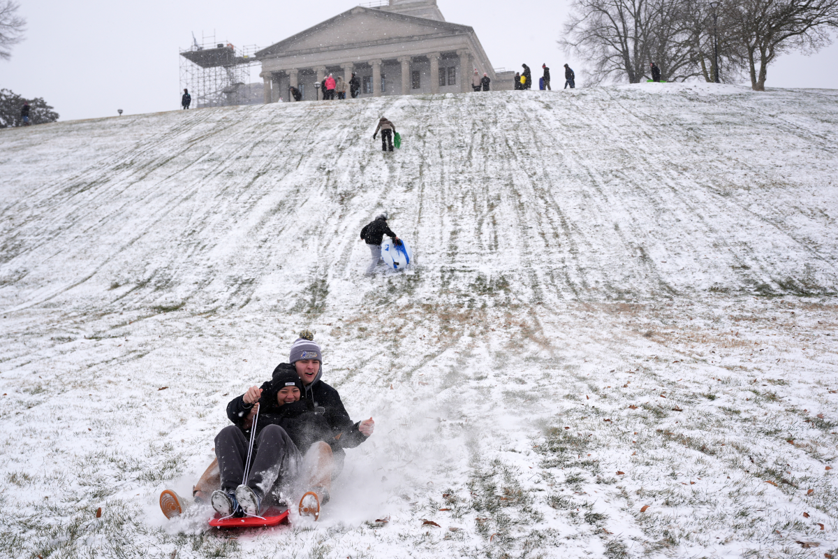 Yana Beeker, front, Roddy Peterson, behind, sled down a hill at the state Capitol during a winter storm in Nashville, Tenn.