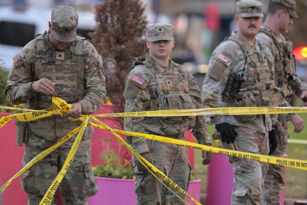 National Guard members respond to the shooting of two West Virginia Guard members near the White House on Wednesday.