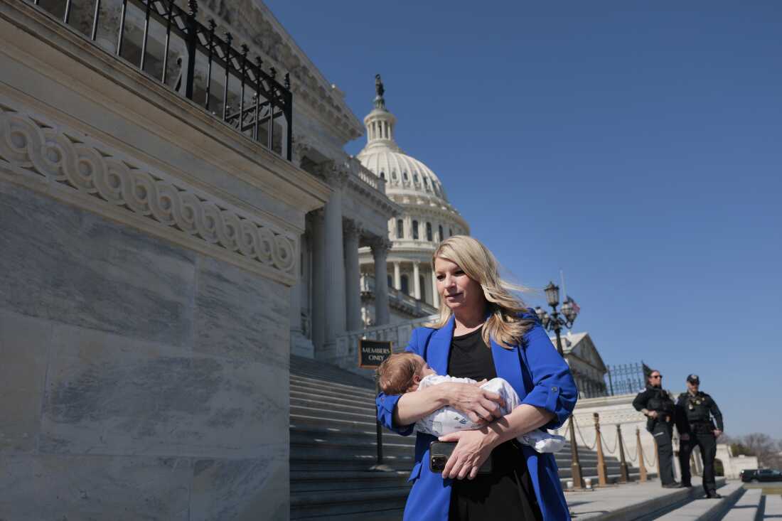 Rep. Brittany Pettersen, D-Colo., holds her one-month old baby as she departs during a series of votes at the Capitol on March 11. Petterson has been working with Rep. Anna Paulina Luna, R-Fla., to pass legislation to allow proxy voting for up to 12 weeks for members who have recently given birth or whose spouse has.