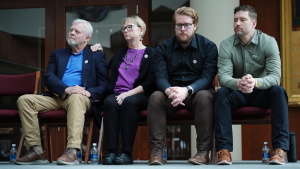 The family of Renee Good, from left; father Tim Ganger, mother Donna Ganger, brother Luke Ganger and brother Brent Ganger, listen during a news conference after the family sued the U.S. government and several immigration officials, Thursday, Oct. 1, 2026, in Minneapolis.