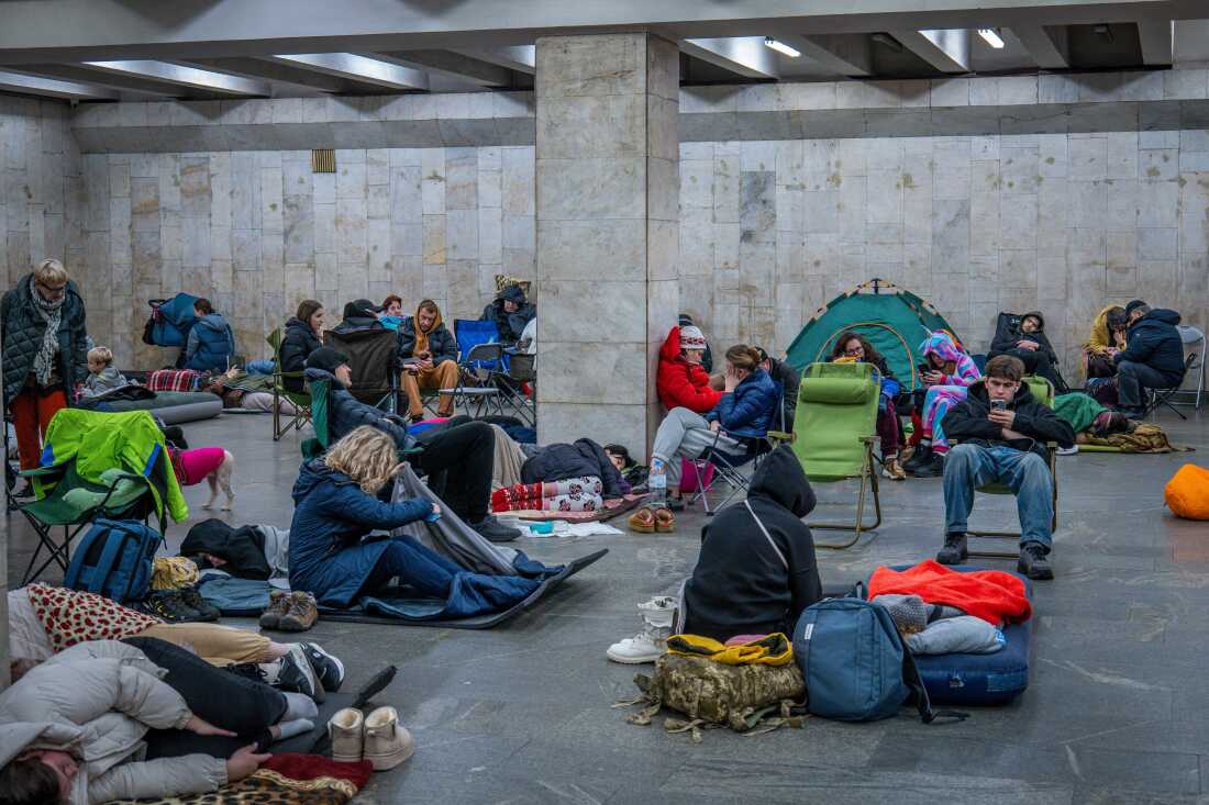 People hide in a metro station, being used as a bomb shelter, during a Russian drones attack in Kyiv, Ukraine, early Friday, Nov. 14, 2025.
