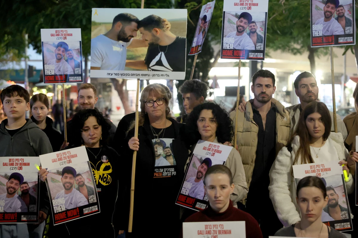 Twins hold portraits of Gali and Ziv Berman, who were taken by Palestinian militants on the Oct. 7 attack and since held hostage in the Gaza Strip, during a rally calling for their release, in the Israeli coastal city of Tel Aviv.