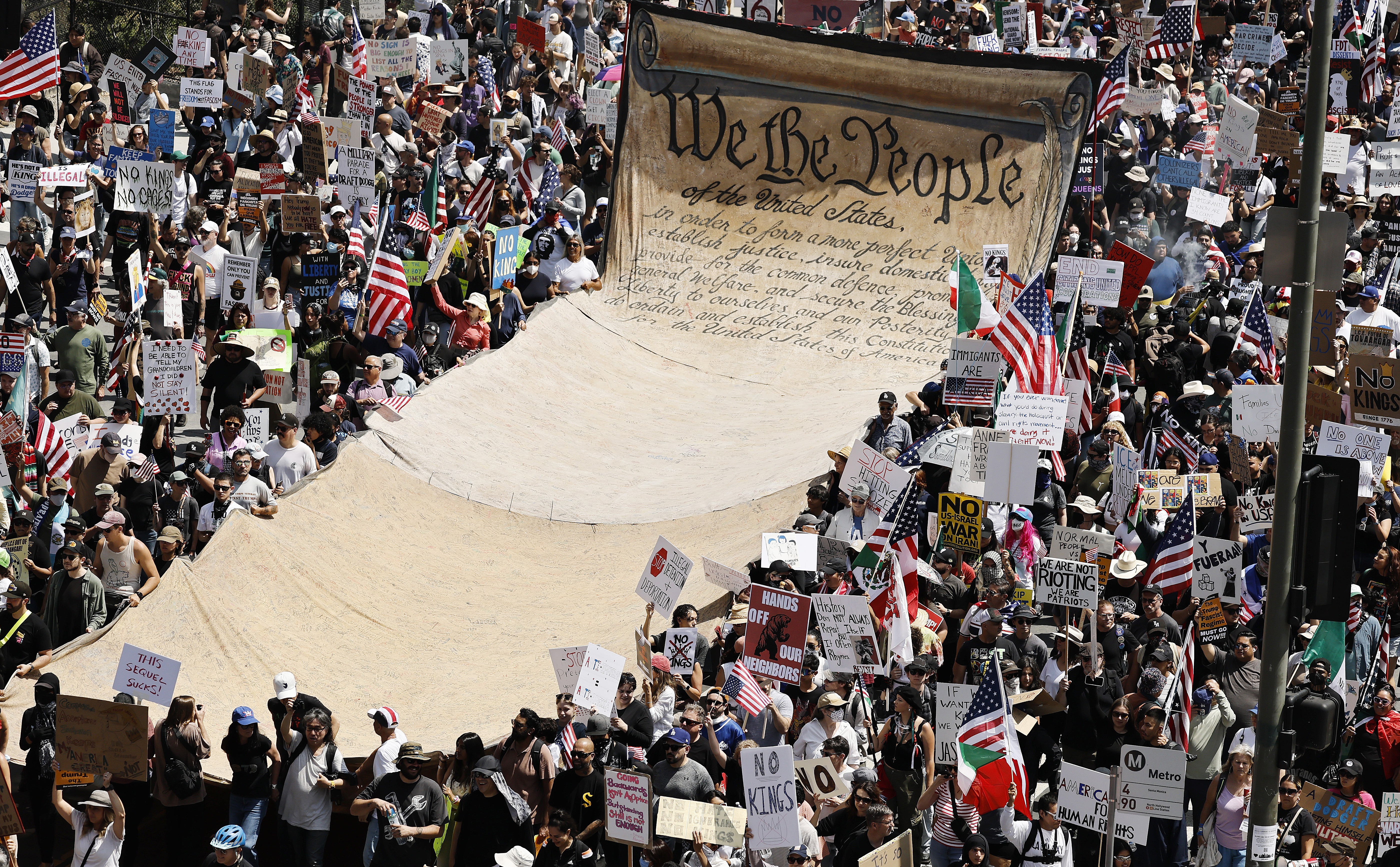 Protesters carry a banner representing the preamble to the U.S. Constitution in downtown Los Angeles during an anti-Trump No Kings Day demonstration on June 14.