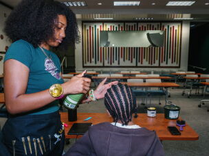 Being part of the Black Honors College has helped Naomi Thrower, a junior, get in touch with her black identity. She runs a natural hair business on campus and says it's helped her develop a creative expression.