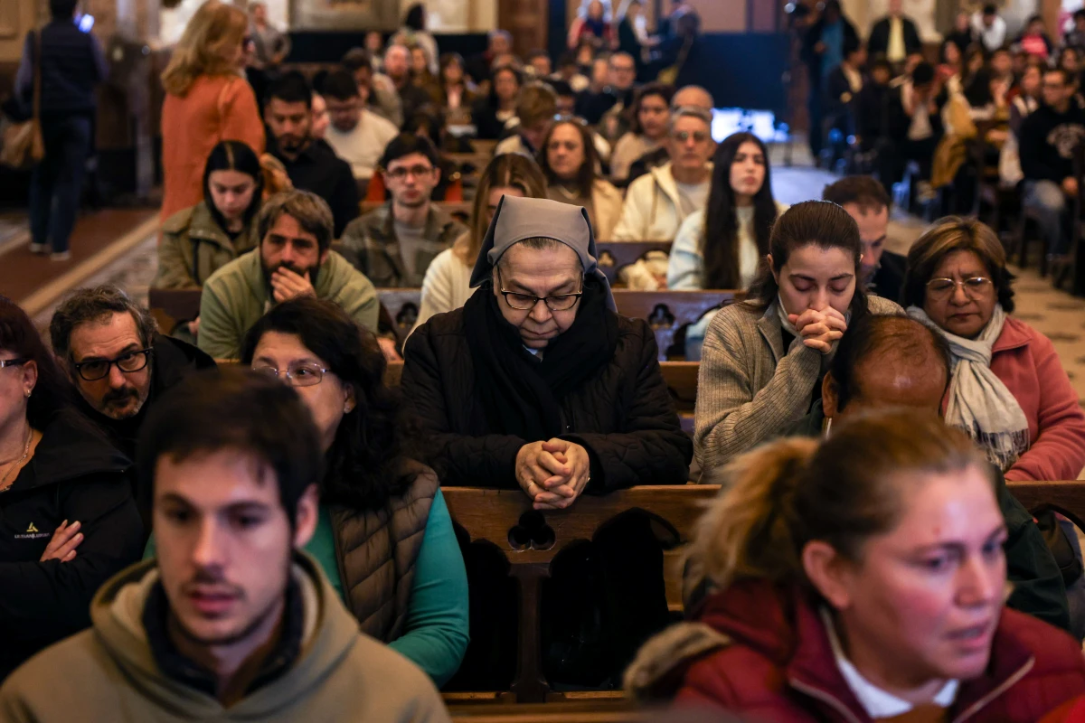 People pray during a service for Pope Francis in Buenos Aires Cathedral on Monday.