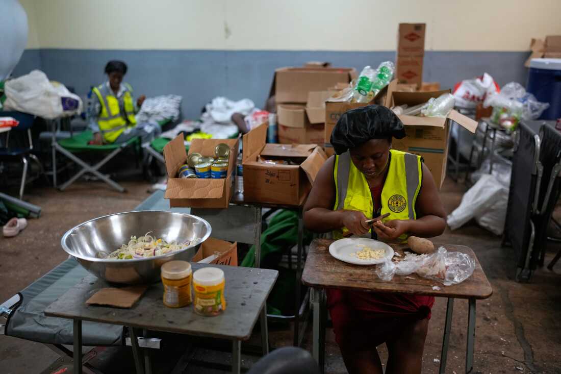 Cooks prepare meals at a shelter set up at a school ahead of Hurricane Melissa's expected landfall in Old Harbour, Jamaica, on Monday.