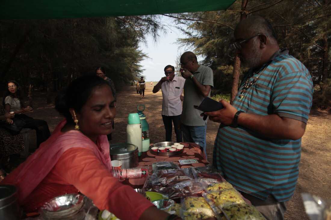 Visitors buy snacks after watching turtle hatchlings crawl to the shore by the western Indian village of Velas.