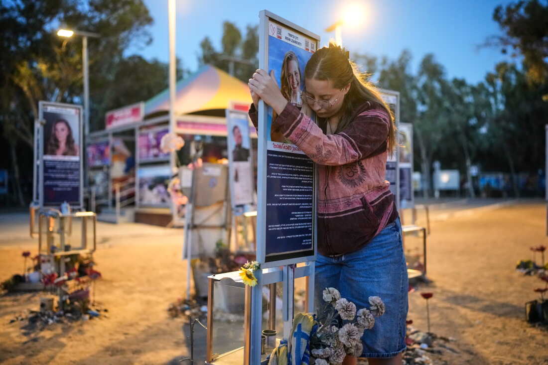 Raz Zarfati, sister of Ron Zarfati who was killed in the Oct. 7, 2023, Hamas attack on Israel, attend a memorial marking the third anniversary of the attack at the Nova music festival site near Kibbutz Reim, southern Israel, Wednesday, Oct. 7, 2026.