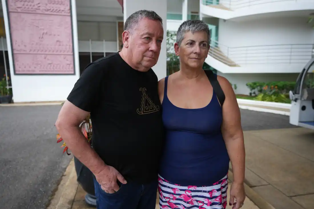 A couple passenger from a U.S. cruise ship, the MV Odyssey, Paul Montoya, left, stands for an interview with his wife, Lynn Motoya, at the Independence Hotel in Sihanoukville, Cambodia, Wednesday, Oct. 28, 2026.