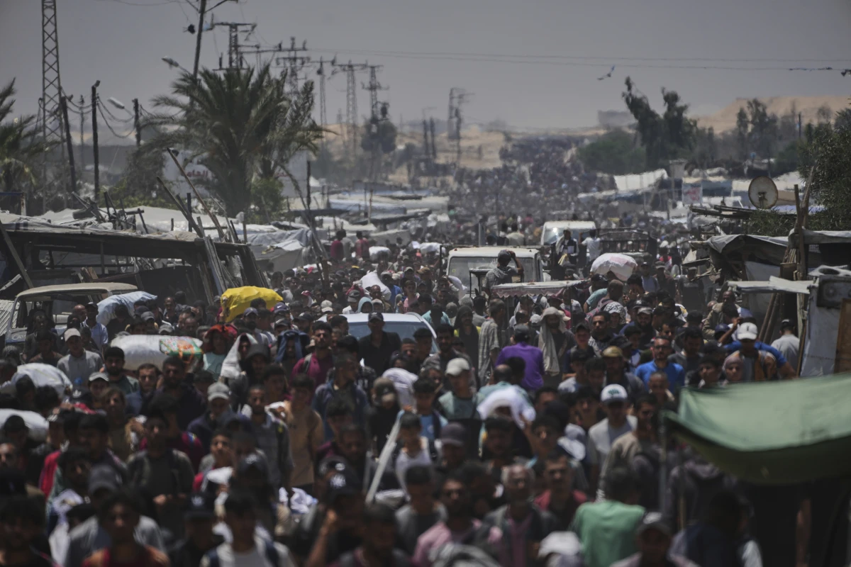 Palestinians carry bags containing food and humanitarian aid packages delivered by the Gaza Humanitarian Foundation, a U.S.-backed organization, in Rafah, southern Gaza Strip, Sunday, June 8, 2025.