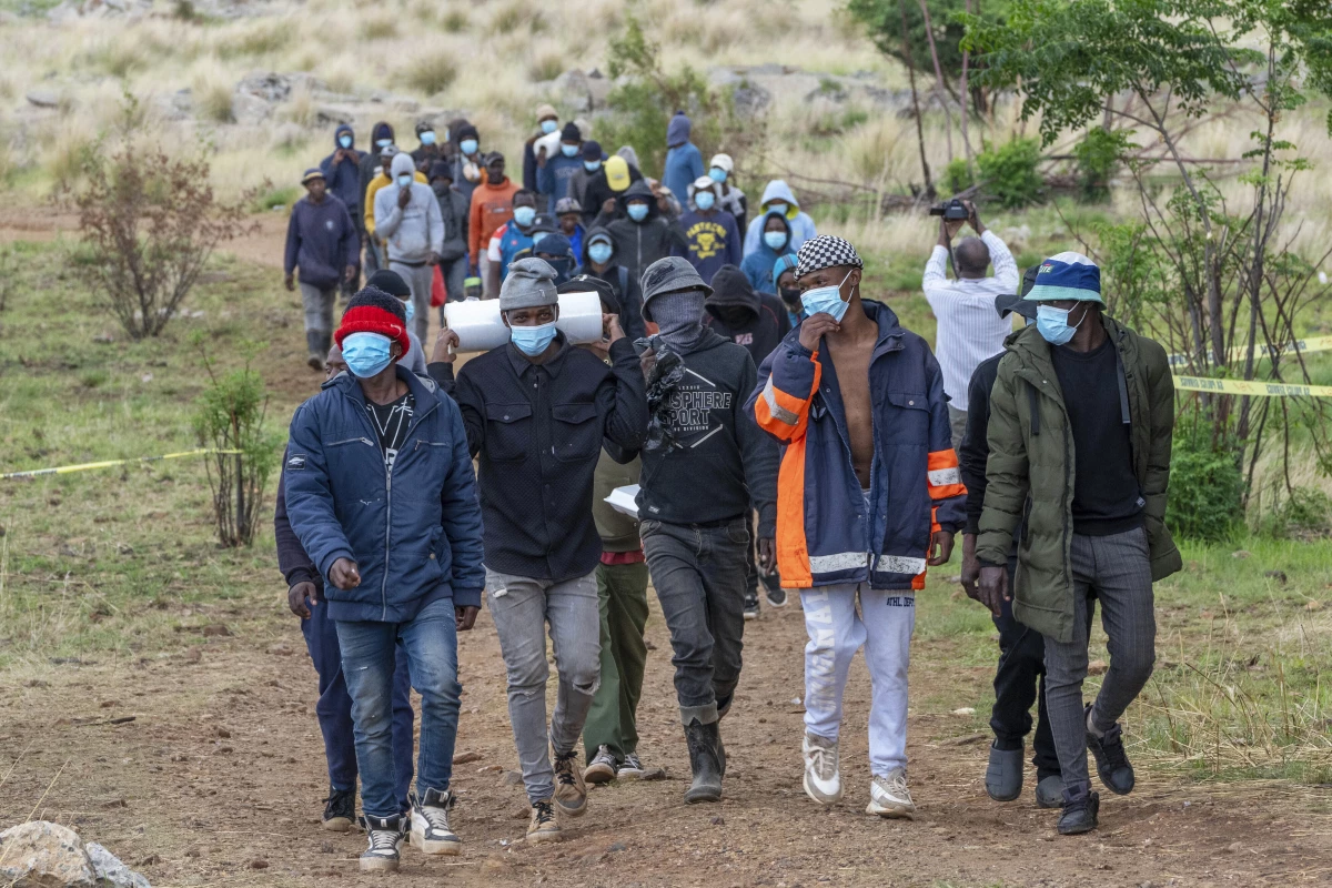 Volunteer rescue workers and community members leave the area near a closed mine where illegal miners are inside in Stilfontein, South Africa on Thursday.