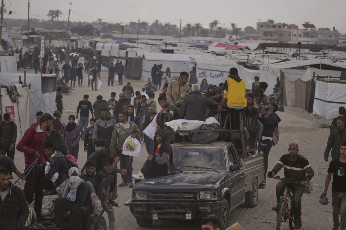Palestinians carry bags filled with food and humanitarian aid provided by the Gaza Humanitarian Foundation, a U.S.-backed organization approved by Israel, in Khan Younis, southern Gaza Strip, on Tuesday, June 3.