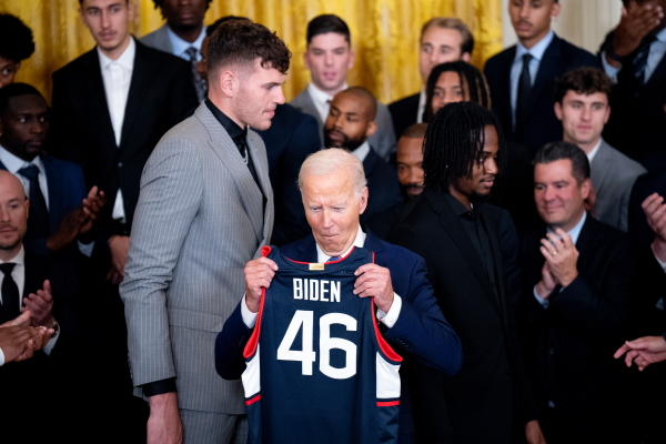 University of Connecticut Huskies basketball players present President Biden with a jersey during a celebration of their NCAA championship season at the White House on Sept. 10, 2024.