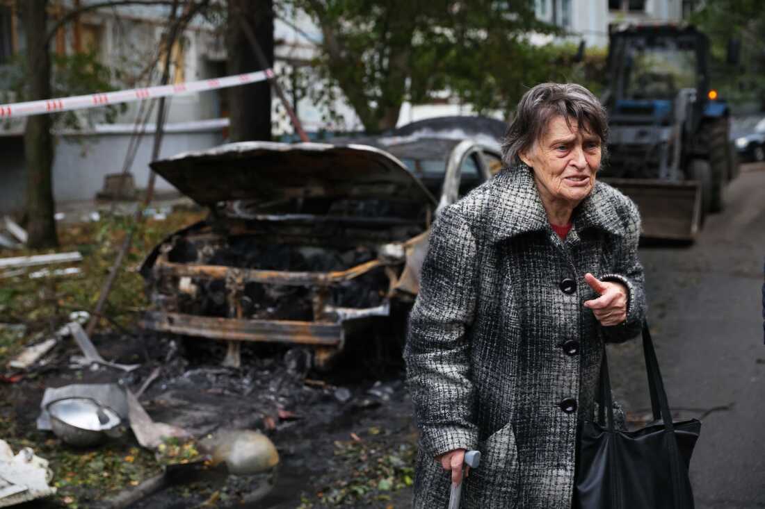 An elderly woman reacts next to the house destroyed by a Russian strike in Zaporizhzhia, Ukraine, Sunday, Oct. 5, 2025.