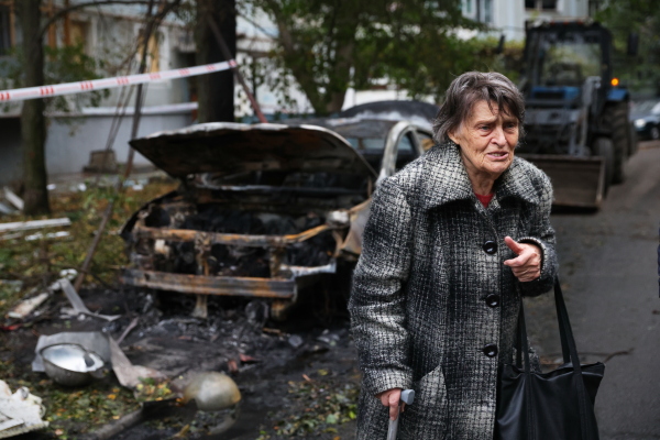 An elderly woman reacts next to the house destroyed by a Russian strike in Zaporizhzhia, Ukraine, Sunday, Oct. 5, 2025.