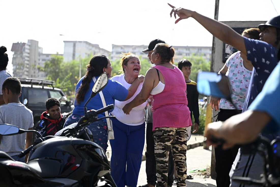People react near a damaged apartment building following an earthquake in Catia La Mar, La Guaira state, about 30 km northwest of Caracas.