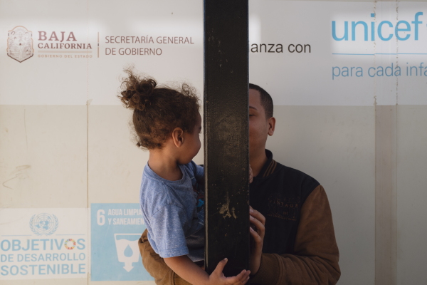 Andres Patiño plays with his son outside the Embajadores de Jesús church in Tijuana, Mexico, on Dec. 6, 2024.