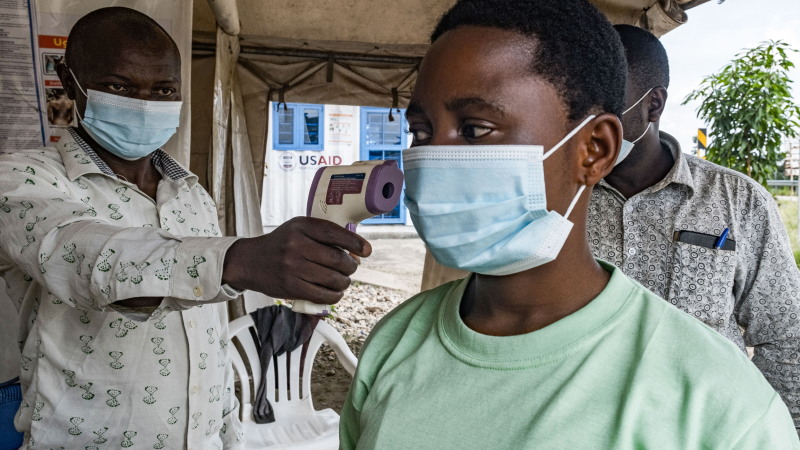 A border health officer at the Busunga crossing between Uganda and the Democratic Republic of Congo checks a traveler's temperature using a contactless infrared thermometer in Bundibugyo, on May 18, 2026. Ugandan officials confirmed that a 59-year-old man from Democratic Republic of Congo had died in Kampala after being admitted earlier in the week. Tests showed the victim in Uganda was infected with the Bundibugyo strain of Ebola, first identified in 2007. The World Health Organization declared an international health emergency on May 17, 2026 over an outbreak of an Ebola strain in the Democratic Republic of Congo that has killed more than 80 and for which there is no vaccine. Fears of further spread grew when a laboratory confirmed a case in the major eastern DRC city of Goma, which is controlled by the Rwanda-backed M23 militia.