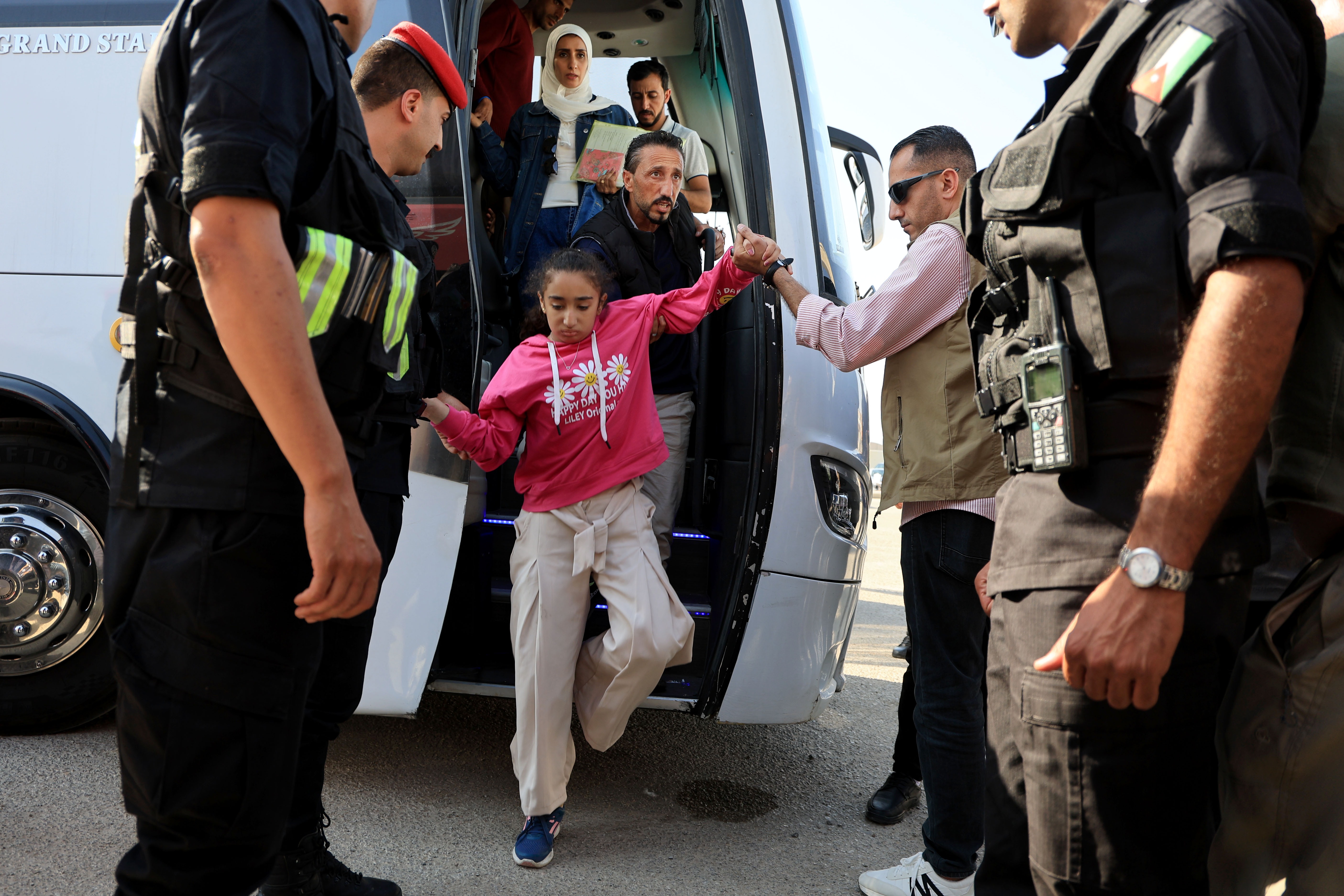 A child gets off a bus near the Jordanian border with other pediatric patients who have been evacuated from Gaza through Israel on June 11.