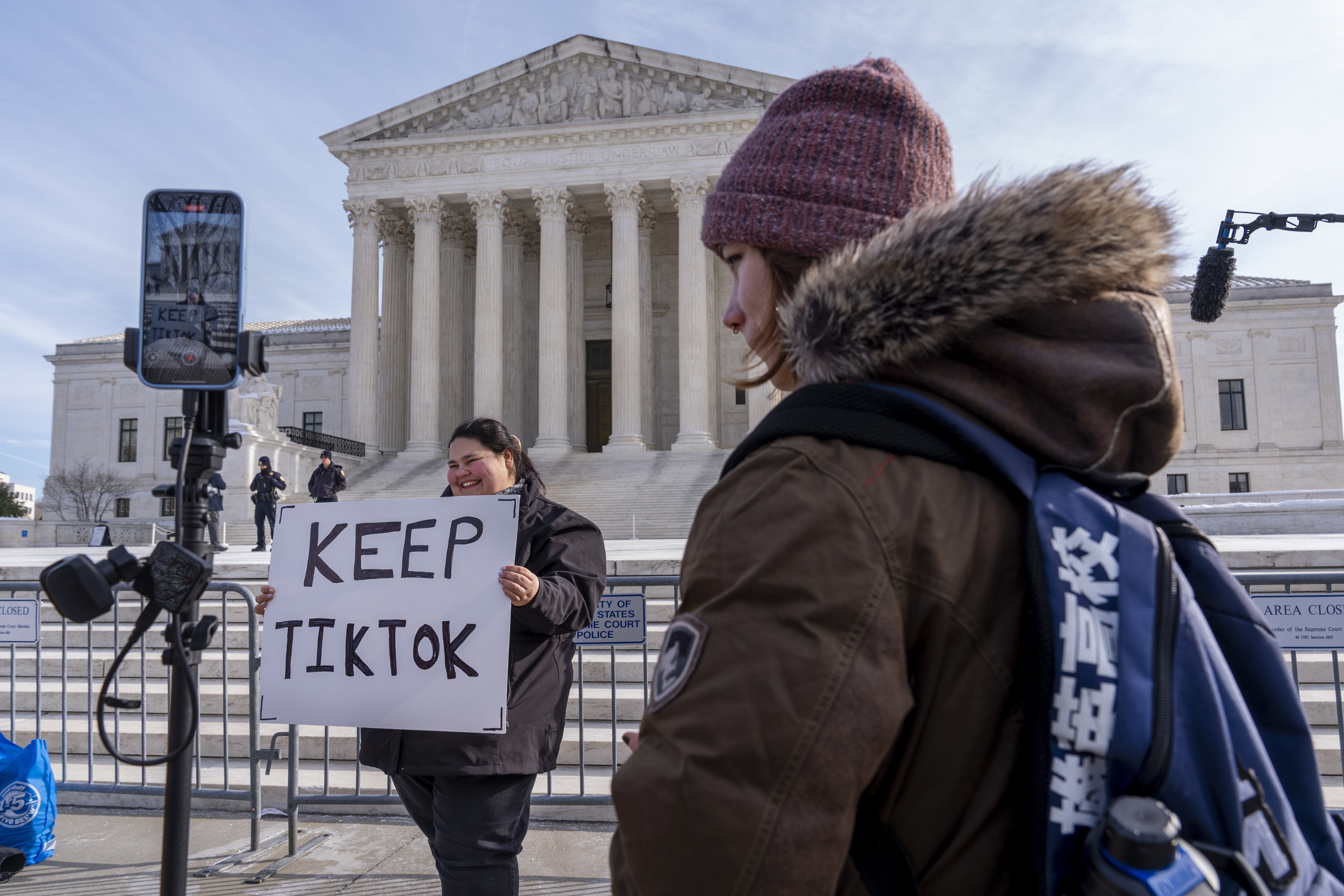 Callie Goodwin of Columbia, S.C., holds a sign in support of TikTok outside the Supreme Court on Jan. 10 in Washington, D.C. Goodwin, a small-business owner who sells personalized greeting cards, says 80% of her sales come from people who found her on TikTok. (AP)