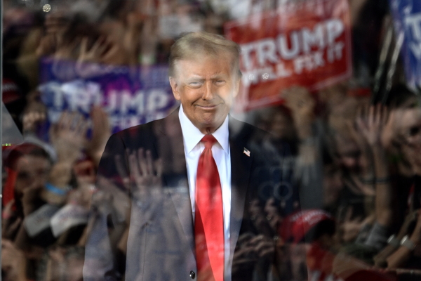 Behind bulletproof glass, former President Donald Trump arrives to speak during a campaign rally in Gastonia, North Carolina, on Saturday.