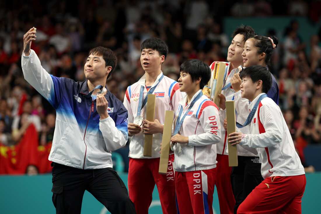 North and South Korean athletes share an Olympic podium — and take a selfie North and South Korean athletes share an Olympic podium — and take a selfie
