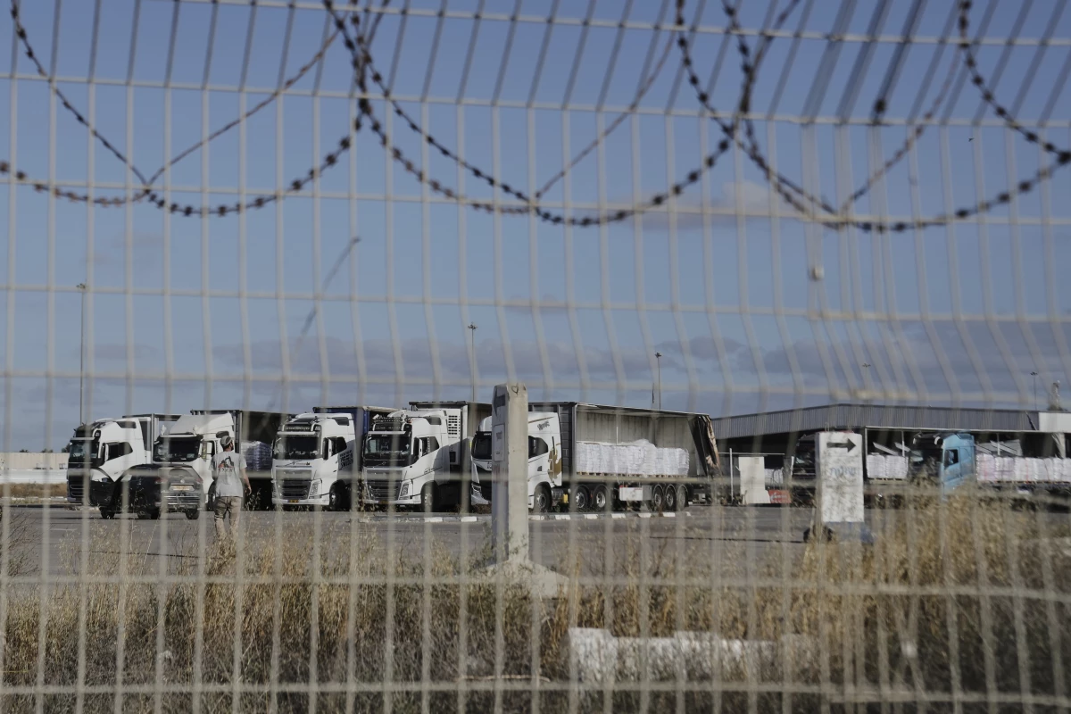 Trucks load with humanitarian aid for the Gaza Strip are seen at the Kerem Shalom Crossing in southern Israel, Tuesday May 20.