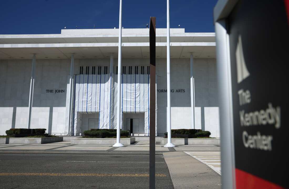 A photo of the entry to the Kennedy Center on Aug. 25, where a large hanging tarp remains in place across the facade, obscuring the name.