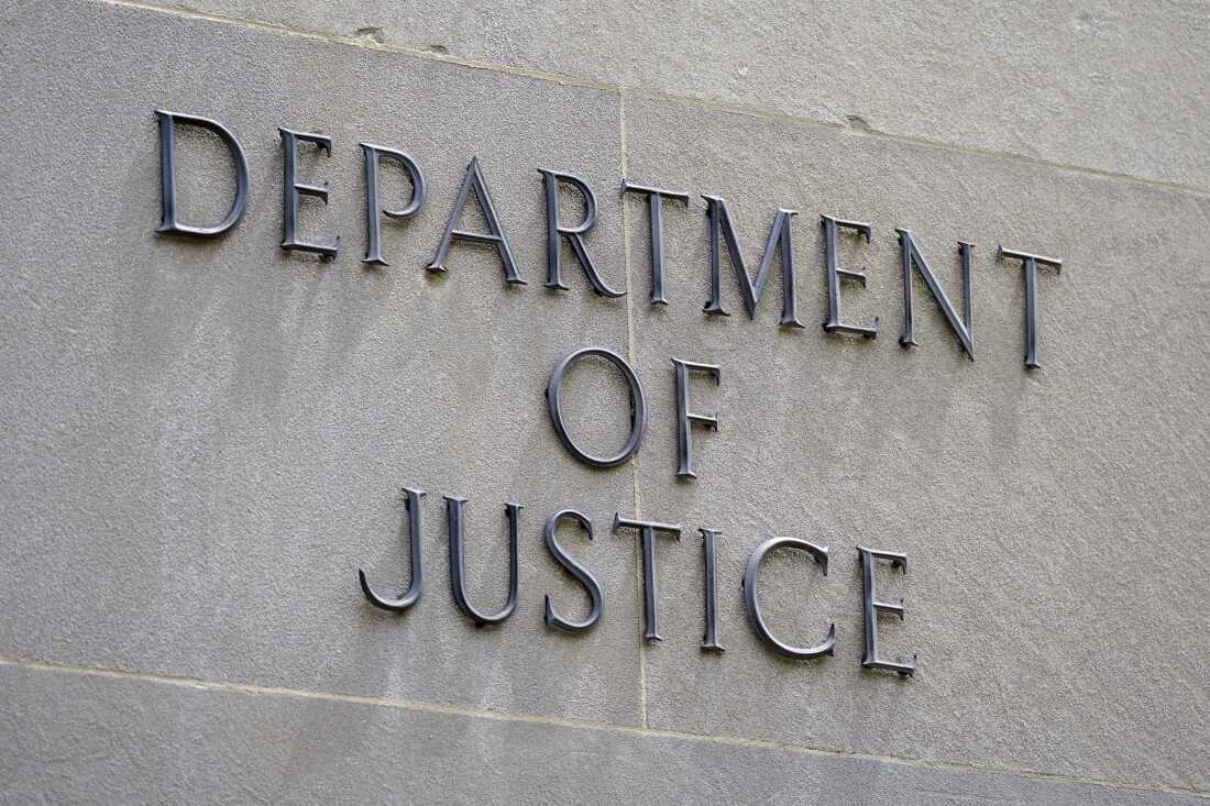 A sign outside the Robert F. Kennedy Department of Justice building is seen in Washington, May 4, 2021. Two former FBI officials have settled lawsuits Friday, July 26, 2024, with the Justice Department to resolve claims that their privacy was violated when the department leaked to the news media text messages that they had sent one another that disparaged former President Donald Trump. (AP Photo/Patrick Semansky)