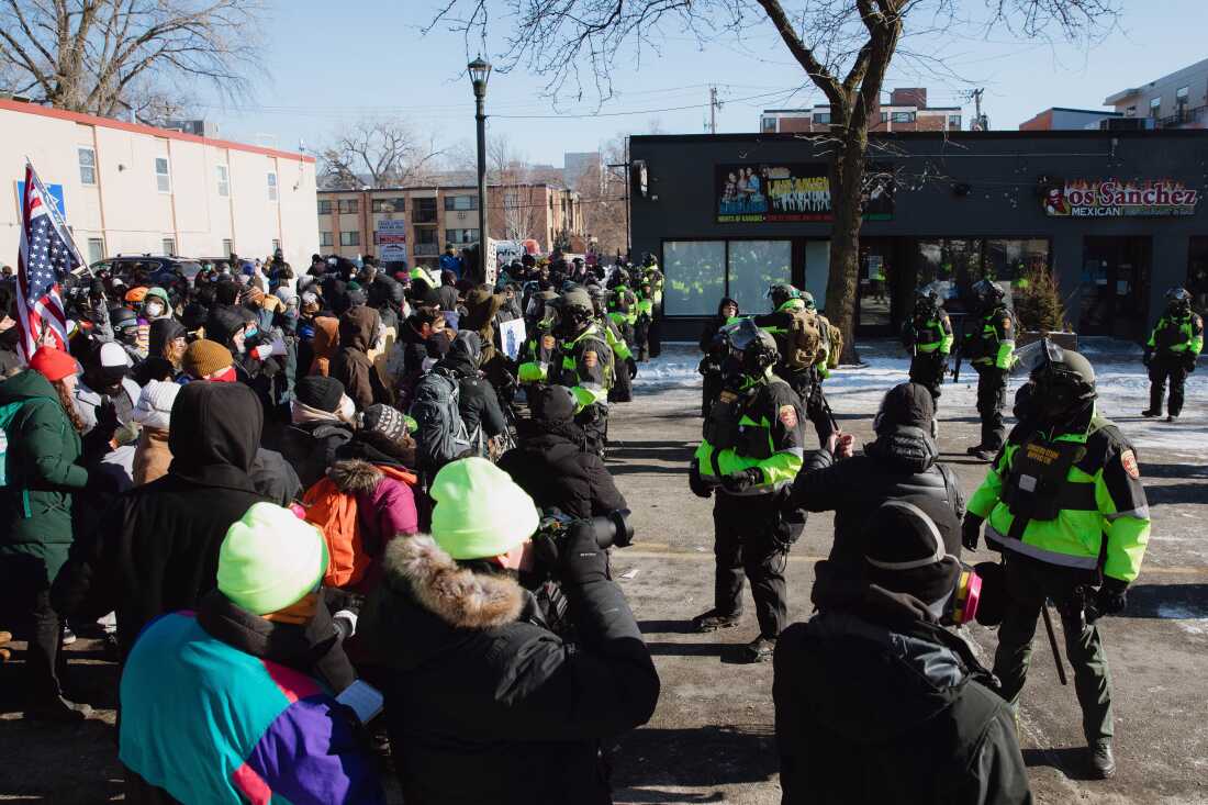 Protesters respond at the site where a federal agent shot and killed a man in Minneapolis on Saturday morning. Jan. 24, 2026 Zaydee Sanchez for NPR