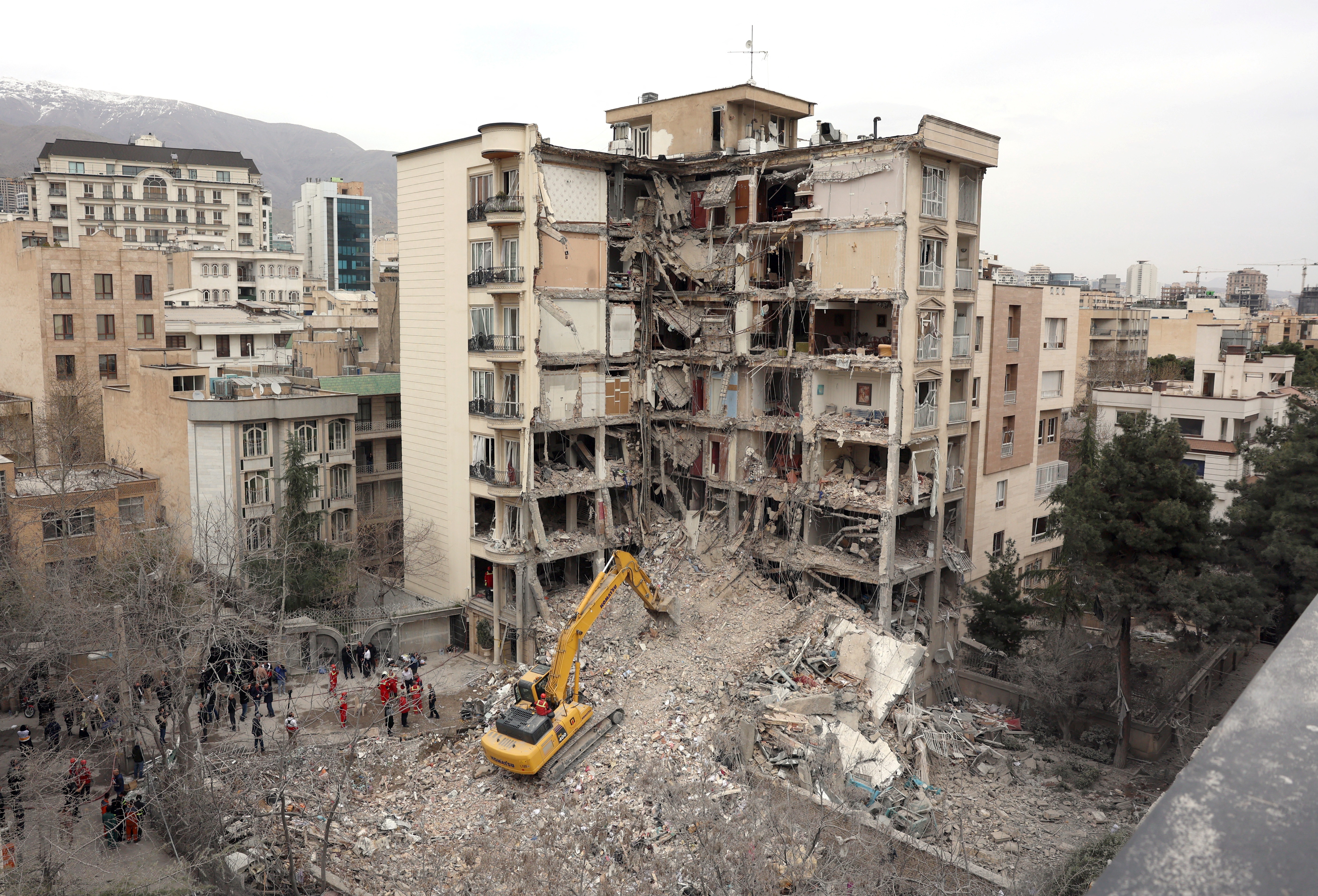 An excavator clears rubble from destroyed residential buildings in northern Tehran, Iran, on Monday, as the U.S. and Israel