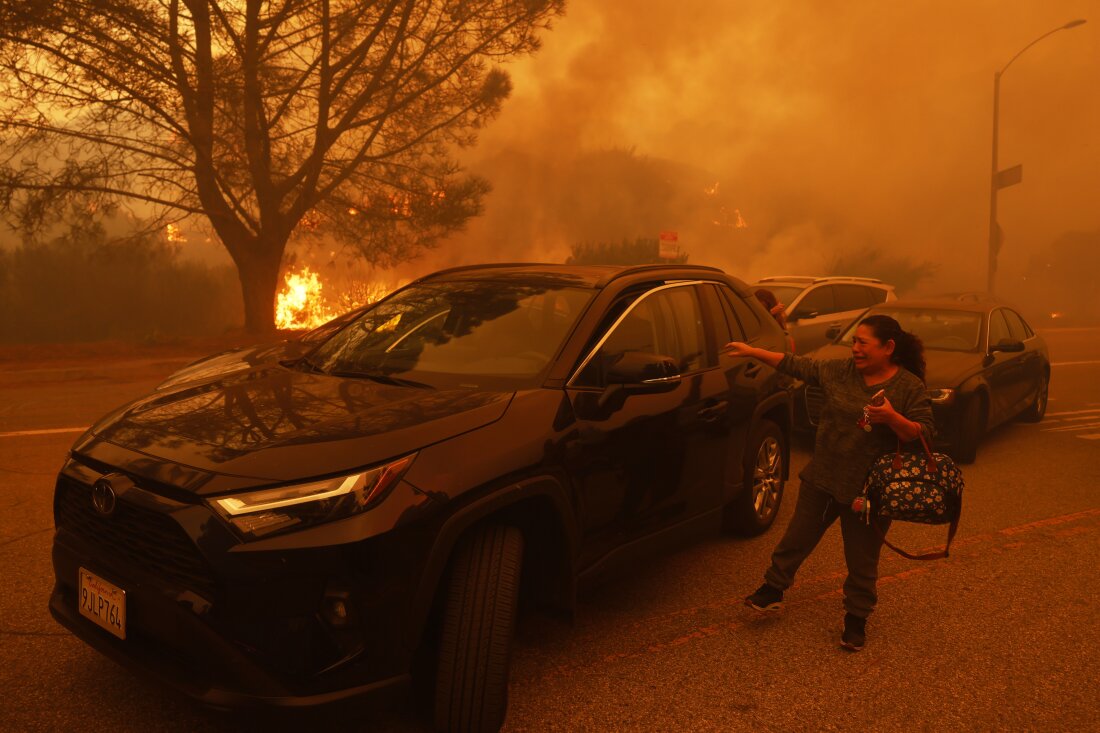 A woman cries as the Palisades Fire advances in the Pacific Palisades neighborhood of Los Angeles Tuesday, Jan. 7, 2025.
