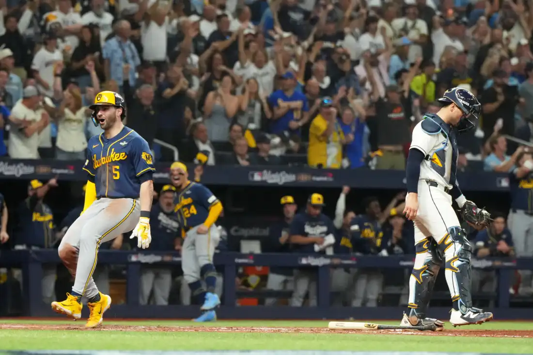 Milwaukee Brewers' Garrett Mitchell, left, celebrates past Tampa Bay Rays catcher Nick Fortes after scoring during the fifth inning of Game 3 of baseball's World Series, Monday, Oct. 26, 2026, in St. Petersburg, Fla., between the Milwaukee Brewers and the Tampa Bay Rays.