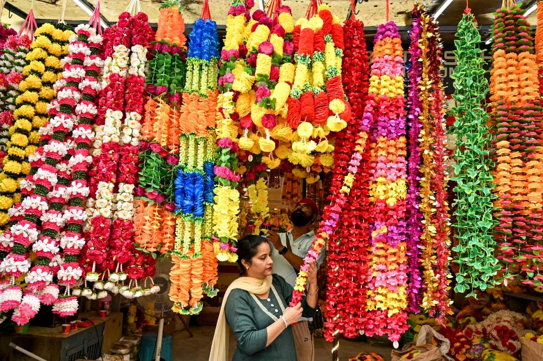 People buy artificial flowers for decorations ahead of Diwali, the Hindu festival of lights, at a market in Amritsar on Oct. 28, 2024.