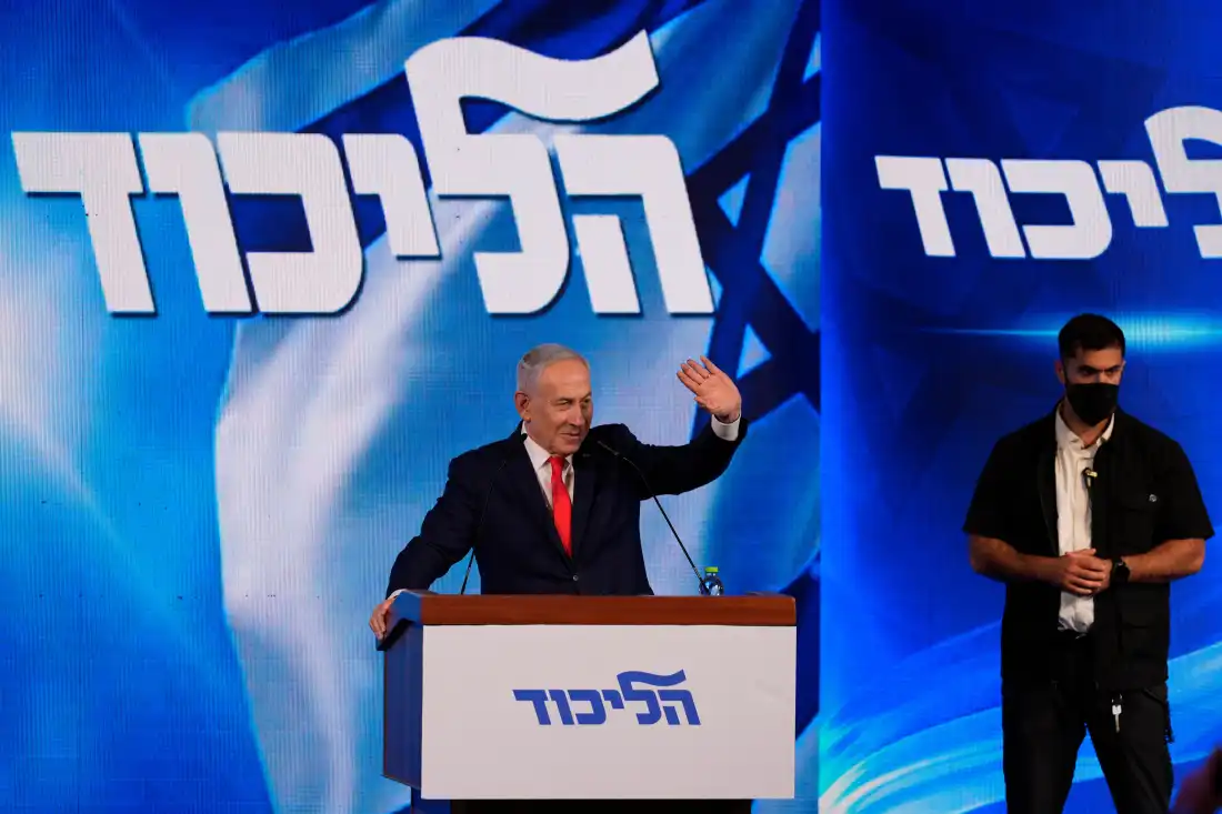 Israeli Prime Minister Benjamin Netanyahu waves to supporters at Likud party headquarters in Jerusalem following the release of the first exit poll results in Israel's general election, Wednesday, Oct. 28, 2026.