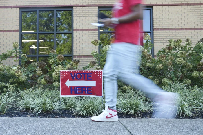 A person walks past a voting sign at the East Point Library on the first day of early voting on October 13, 2026 in Atlanta, Georgia. Early voting will run from October 13th- 30th with Election Day taking place on November 3rd.