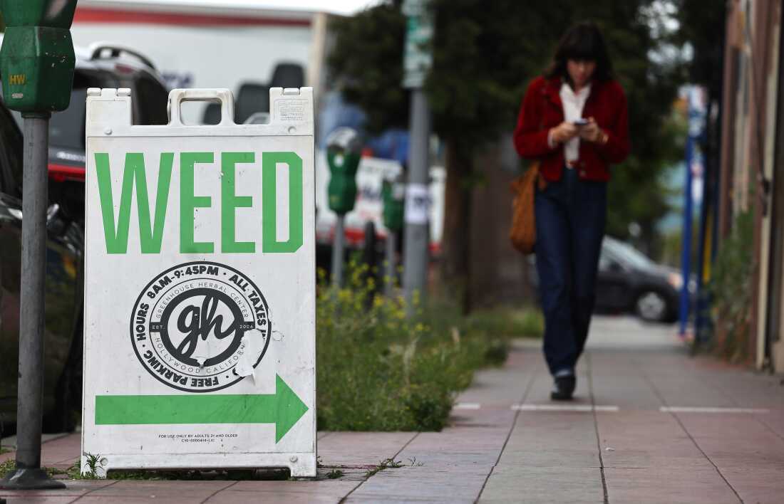A "weed" sign advertises a cannabis dispensary in Los Angeles. With a new Trump administration coming into the White House, marijuana could remain on a path toward relaxed federal restrictions.