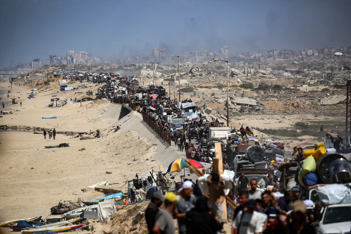 Palestinians from Gaza City move southwards with their belongings, on the coastal road near the Nuseirat refugee camp in the central Gaza Strip, on September 19, 2025.