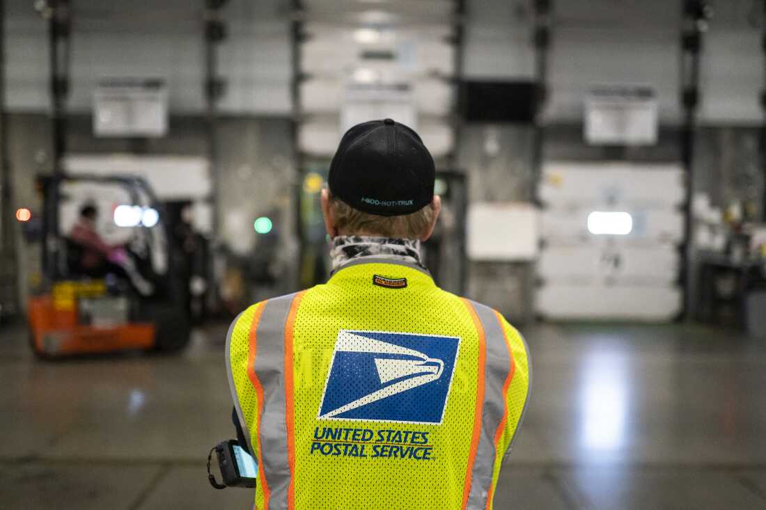 Jim Slowikowski oversees the unloading of pallets filled with mail-in ballots at a U.S. Postal Service processing and distribution center in 2020 in Portland, Ore.