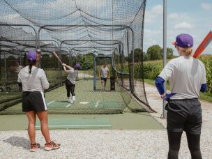 The San Francisco Firebells get in some batting practice at the University of Illinois, Springfield's training field before the WPBL's inaugural weekend on Thursday, July 30.