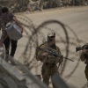 Israeli soldiers stand guard as Syrian Druze people cross back into Syria at the Israeli-Syrian border, in the Israeli-controlled Golan Heights town of Majdal Shams, on Thursday.