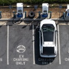 In an aerial view, an electric vehicle charges at an EVgo electric charger on March 30, 2026, in Monrovia, California.